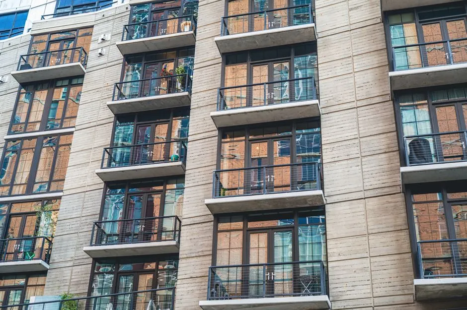 Exterior of a multifamily apartment building with balconies, illustrative of the type of property that can carry a project-based Section 8 contract.